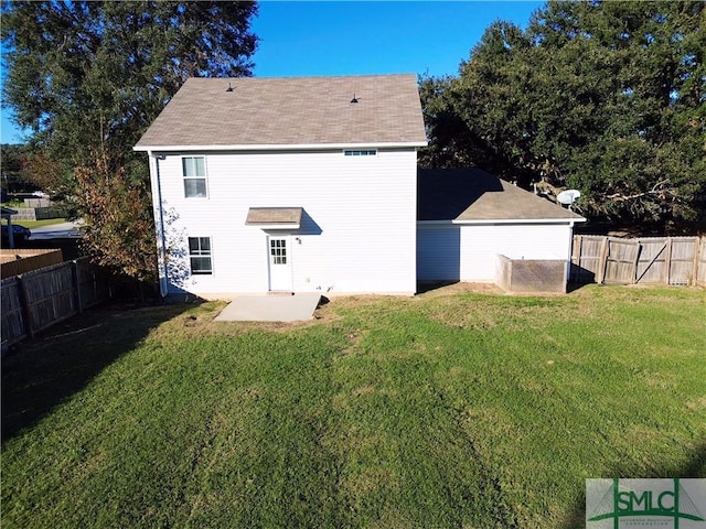 rear view of house with a lawn and a patio area