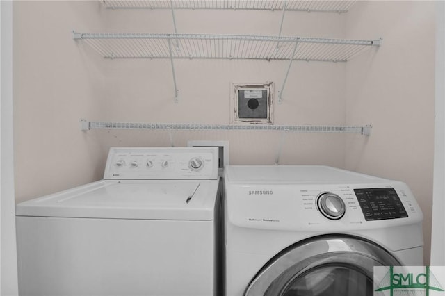 clothes washing area with washer and dryer