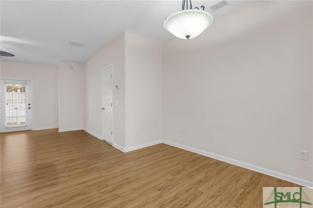 spare room featuring hardwood / wood-style flooring