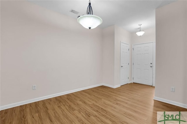 unfurnished room with light wood-type flooring