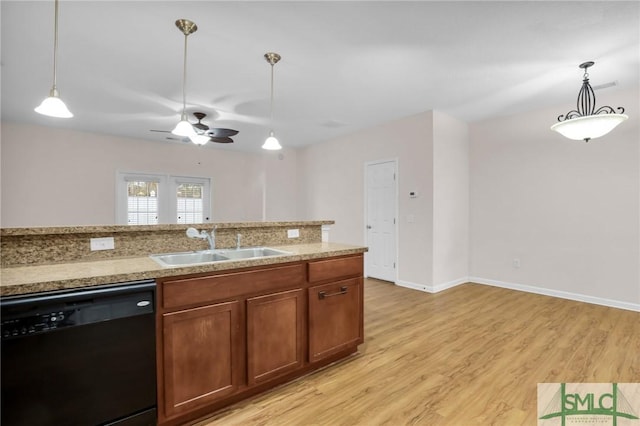 kitchen with sink, light hardwood / wood-style floors, hanging light fixtures, and black dishwasher