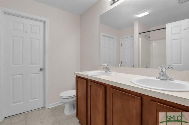 bathroom featuring vanity, tile patterned floors, and toilet