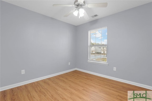 spare room with ceiling fan and light wood-type flooring