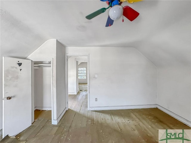 bonus room with ceiling fan, hardwood / wood-style floors, and vaulted ceiling