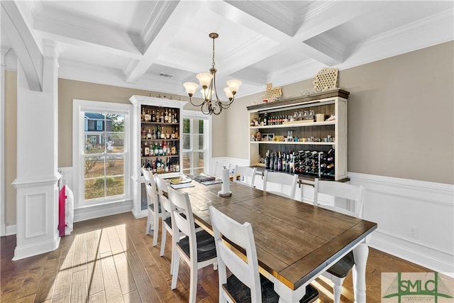 dining room with coffered ceiling, crown molding, dark wood-type flooring, an inviting chandelier, and beamed ceiling