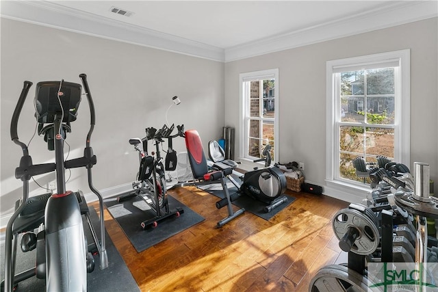 exercise area with hardwood / wood-style flooring and ornamental molding