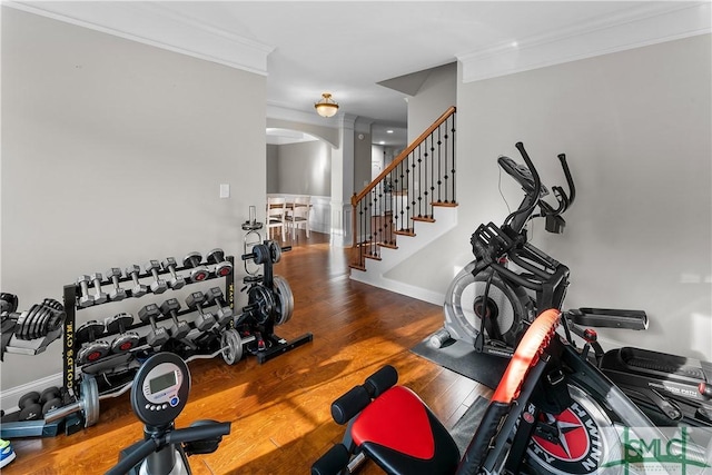 workout area with wood-type flooring and ornamental molding