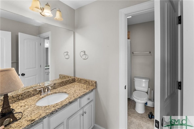 bathroom with tile patterned floors, vanity, and toilet