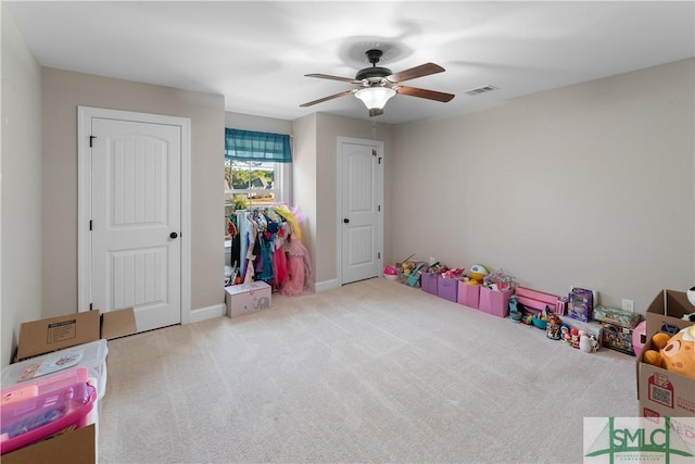 rec room featuring light colored carpet and ceiling fan