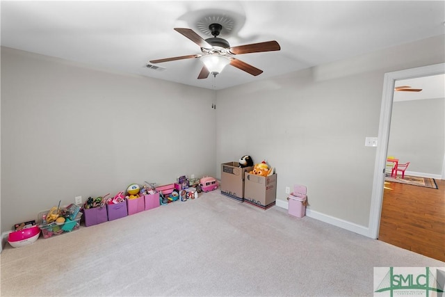 game room with carpet and ceiling fan