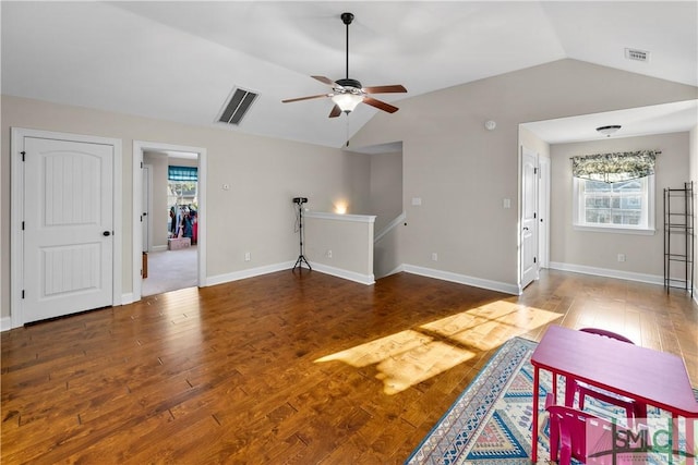 living room featuring ceiling fan, hardwood / wood-style floors, and vaulted ceiling