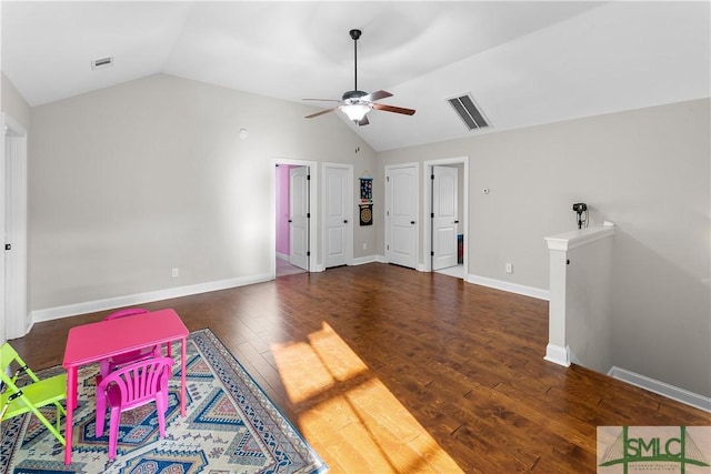 interior space featuring ceiling fan, dark wood-type flooring, and vaulted ceiling