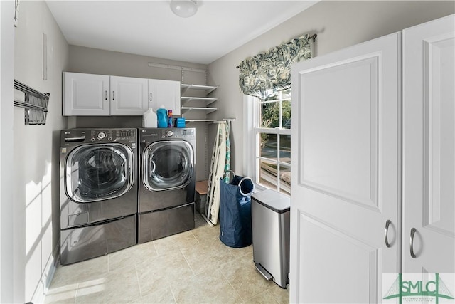 laundry area with cabinets, light tile patterned floors, and separate washer and dryer