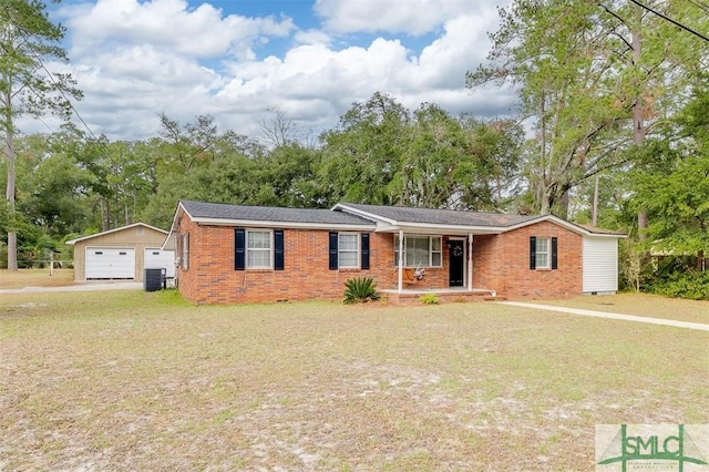 single story home featuring a front lawn, an outbuilding, central AC unit, covered porch, and a garage