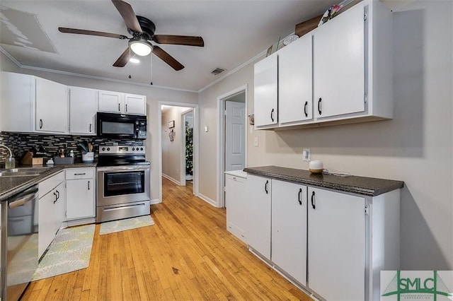 kitchen featuring white cabinets, light wood-type flooring, stainless steel appliances, and sink