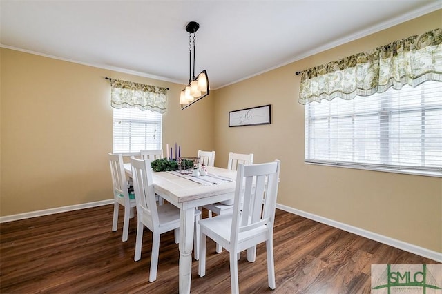 dining space featuring crown molding and dark wood-type flooring