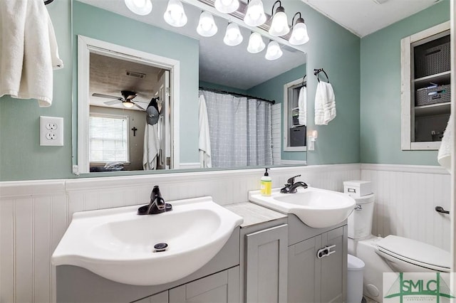 bathroom with vanity, toilet, and ceiling fan