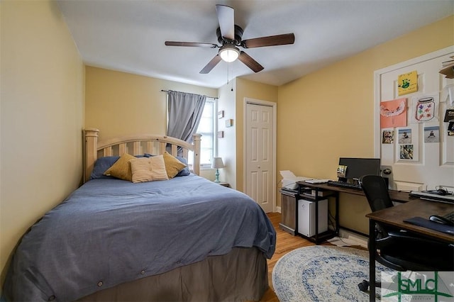 bedroom with ceiling fan, a closet, and light hardwood / wood-style flooring