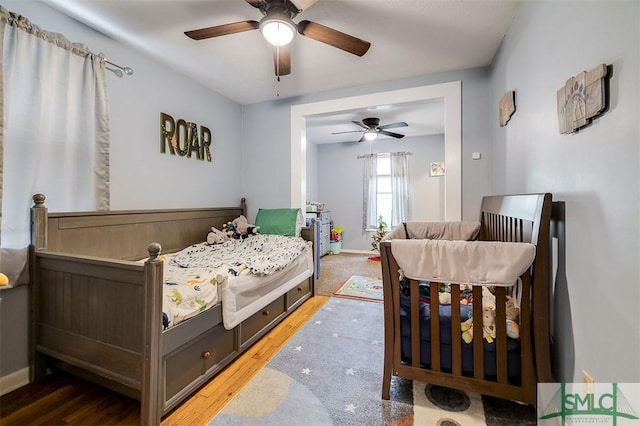 bedroom with hardwood / wood-style flooring and ceiling fan