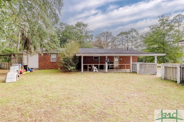 back of property featuring a lawn