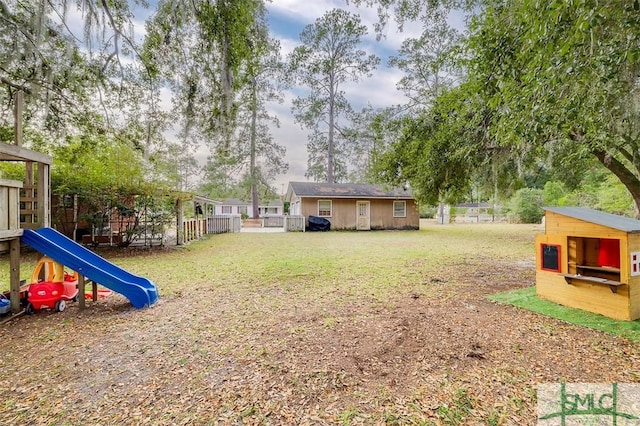 view of yard with a playground and an outdoor structure