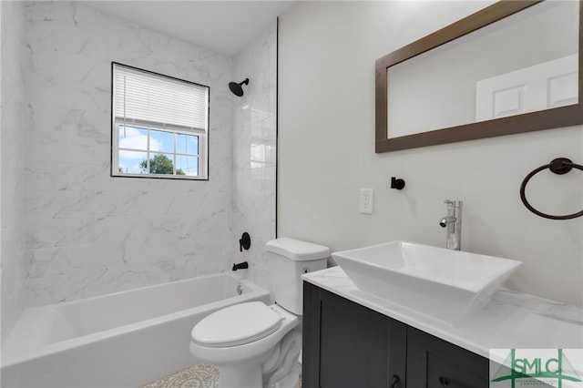 full bathroom featuring vanity, tiled shower / bath combo, and toilet