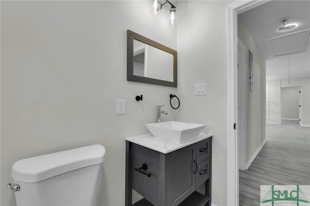 bathroom featuring vanity, hardwood / wood-style flooring, and toilet