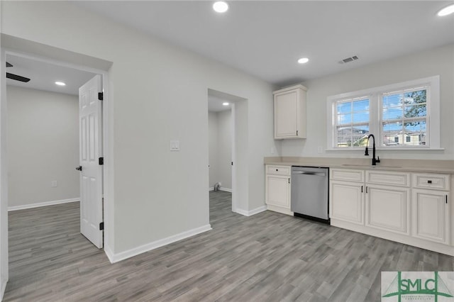 kitchen featuring white cabinets, ceiling fan, sink, light hardwood / wood-style flooring, and dishwasher