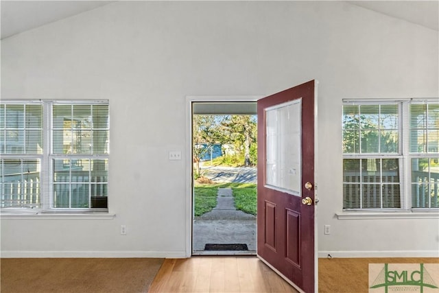 entrance foyer featuring light hardwood / wood-style floors and high vaulted ceiling