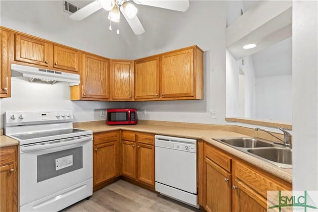 kitchen featuring white appliances, light hardwood / wood-style floors, ceiling fan, and sink