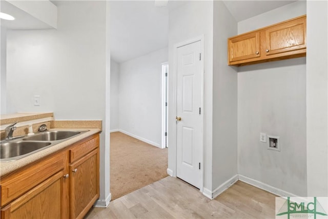 kitchen with sink and light hardwood / wood-style floors