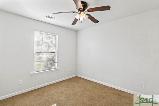 spare room with ceiling fan and carpet