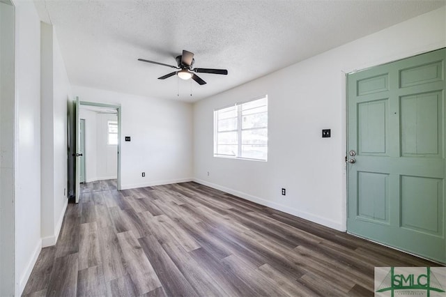 empty room featuring a textured ceiling, hardwood / wood-style flooring, and ceiling fan