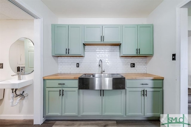 kitchen featuring sink, dark wood-type flooring, wood counters, tasteful backsplash, and green cabinets