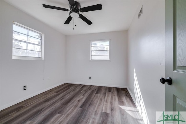 unfurnished room with dark hardwood / wood-style flooring and ceiling fan