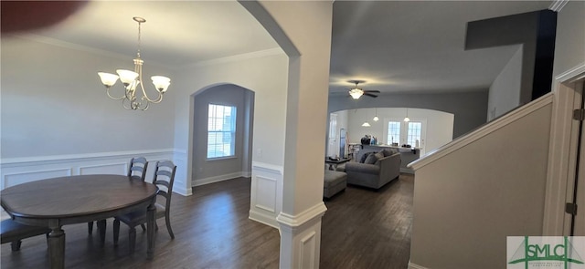 dining area with dark hardwood / wood-style flooring, ceiling fan with notable chandelier, and ornamental molding