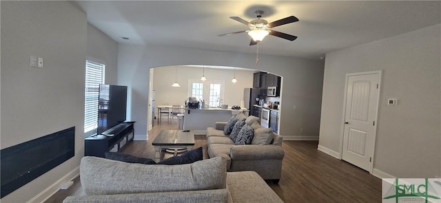 living room featuring french doors, dark hardwood / wood-style flooring, and ceiling fan