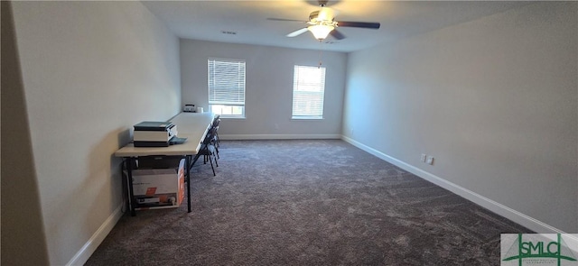 unfurnished office with ceiling fan and dark carpet