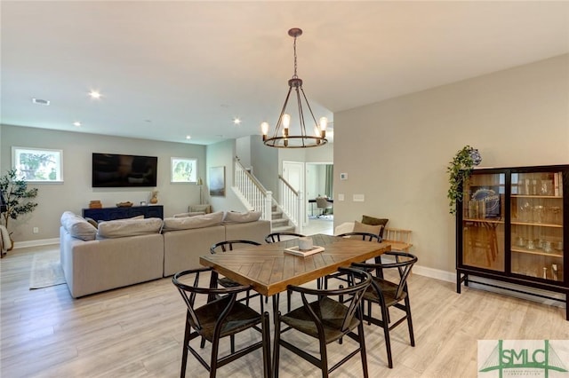 dining space featuring an inviting chandelier, light hardwood / wood-style flooring, and a wealth of natural light