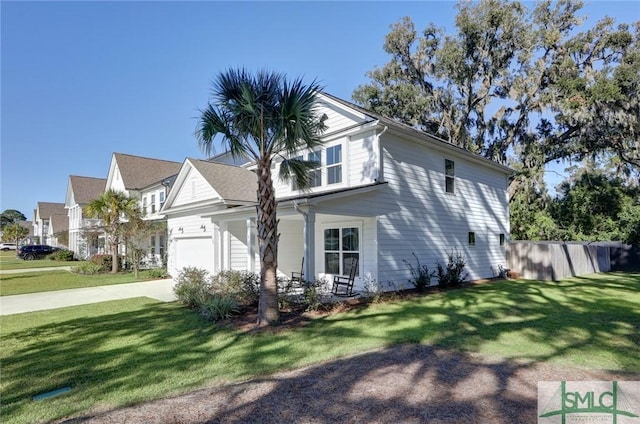 view of side of property with a lawn and a garage