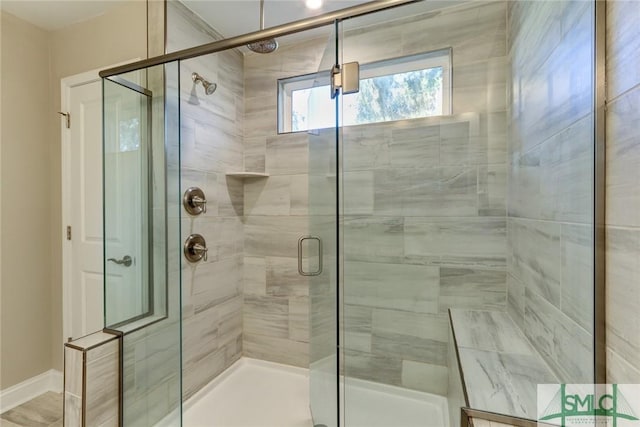 bathroom featuring a shower with door