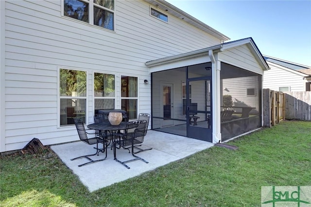 rear view of property featuring a sunroom and a yard