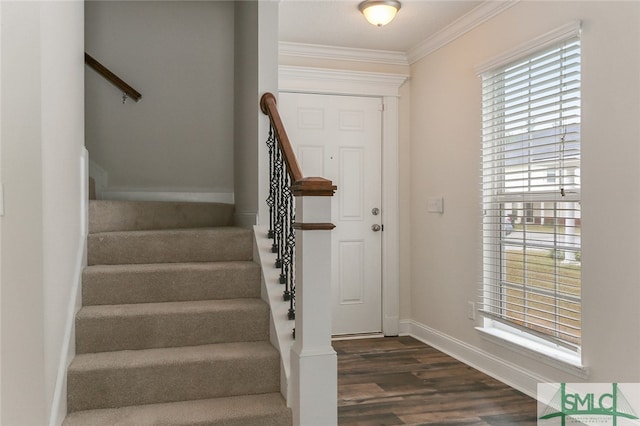 entrance foyer with crown molding and dark wood-type flooring