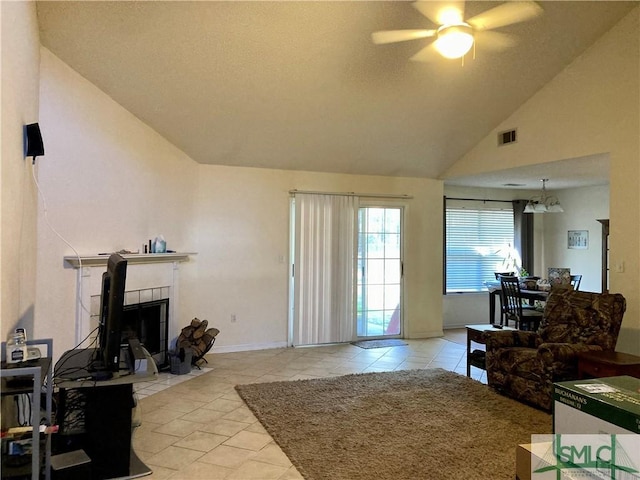 living room featuring ceiling fan, a fireplace, and high vaulted ceiling