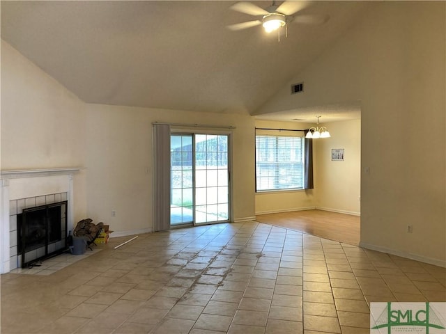 unfurnished living room featuring visible vents, ceiling fan with notable chandelier, a fireplace, and baseboards