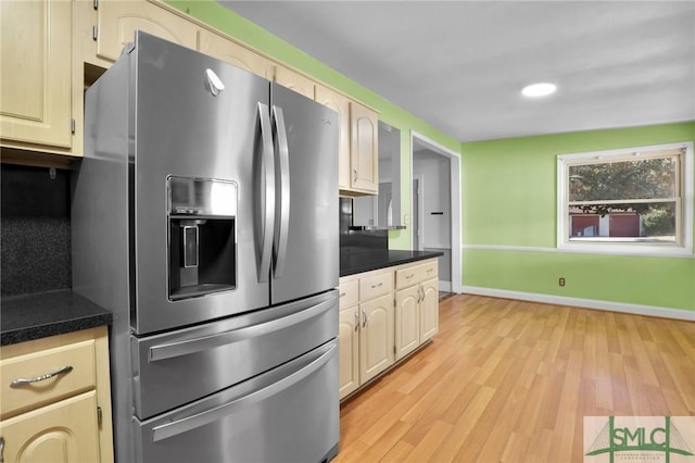 kitchen featuring cream cabinetry, light hardwood / wood-style floors, and stainless steel fridge with ice dispenser