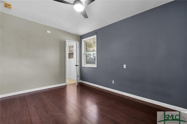 empty room featuring ceiling fan and dark hardwood / wood-style flooring