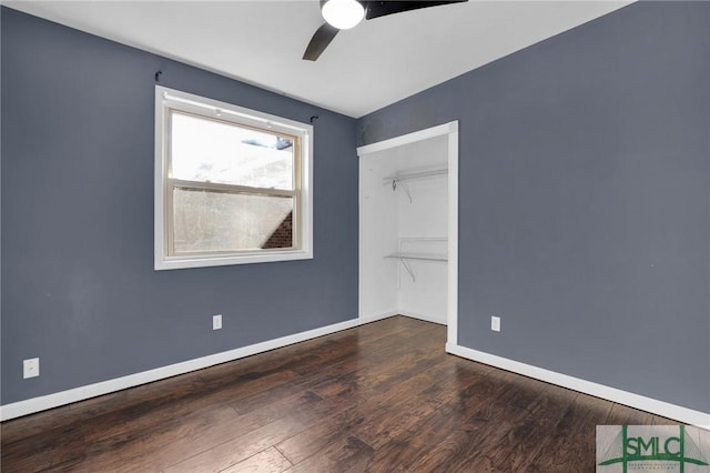 unfurnished bedroom with ceiling fan, a closet, and dark hardwood / wood-style floors