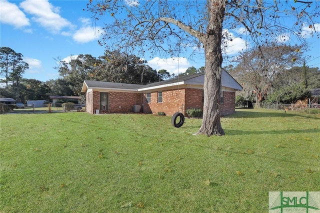 view of side of home with a yard