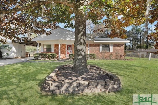 view of front of home with a front yard and a carport